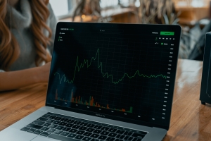 laptop with stock chart and info on screen; market news