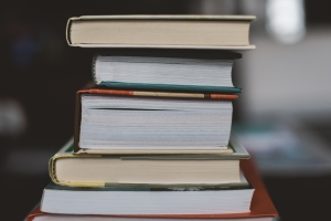 a stack of books, sparking curiosity about ideas and people