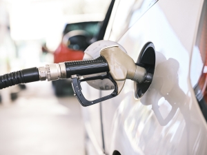 a car refueling with blurry red car in background; Peru's growing energy market